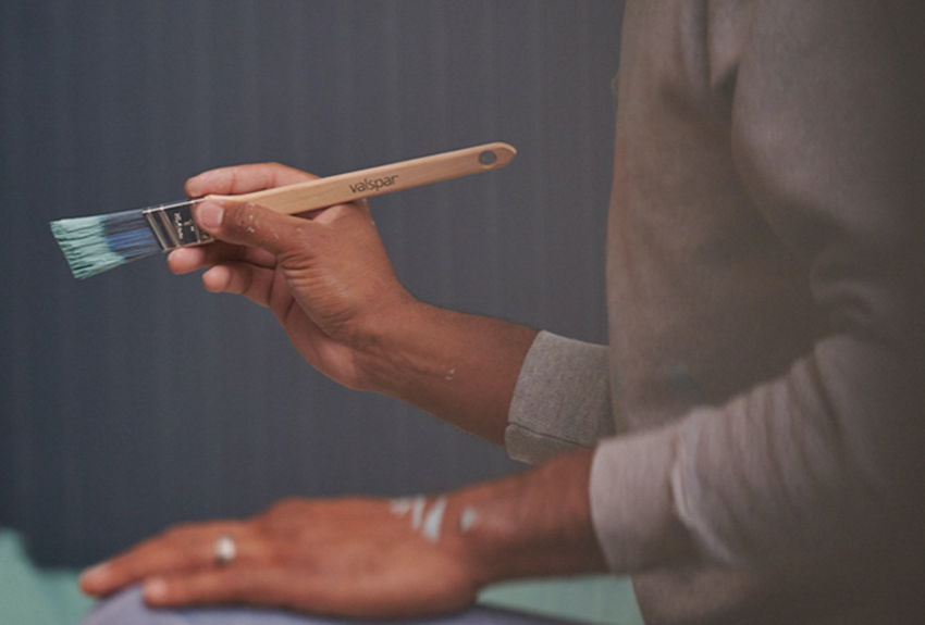 Painter holding a paint brush.