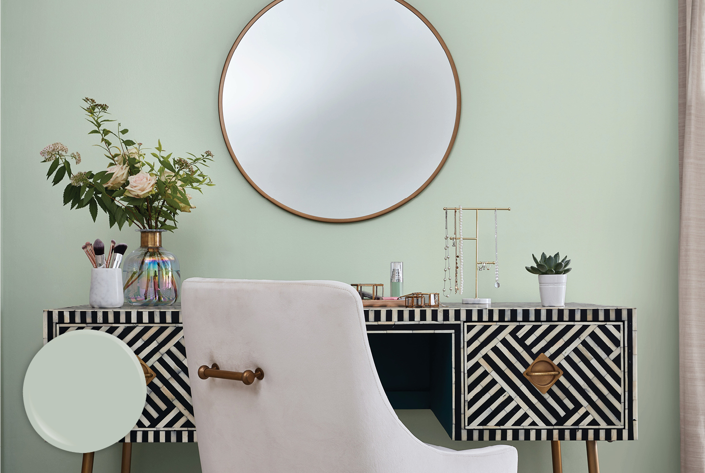 Black and white vanity with flowers, jewelry and makeup brushes against a Garden Flower wall.